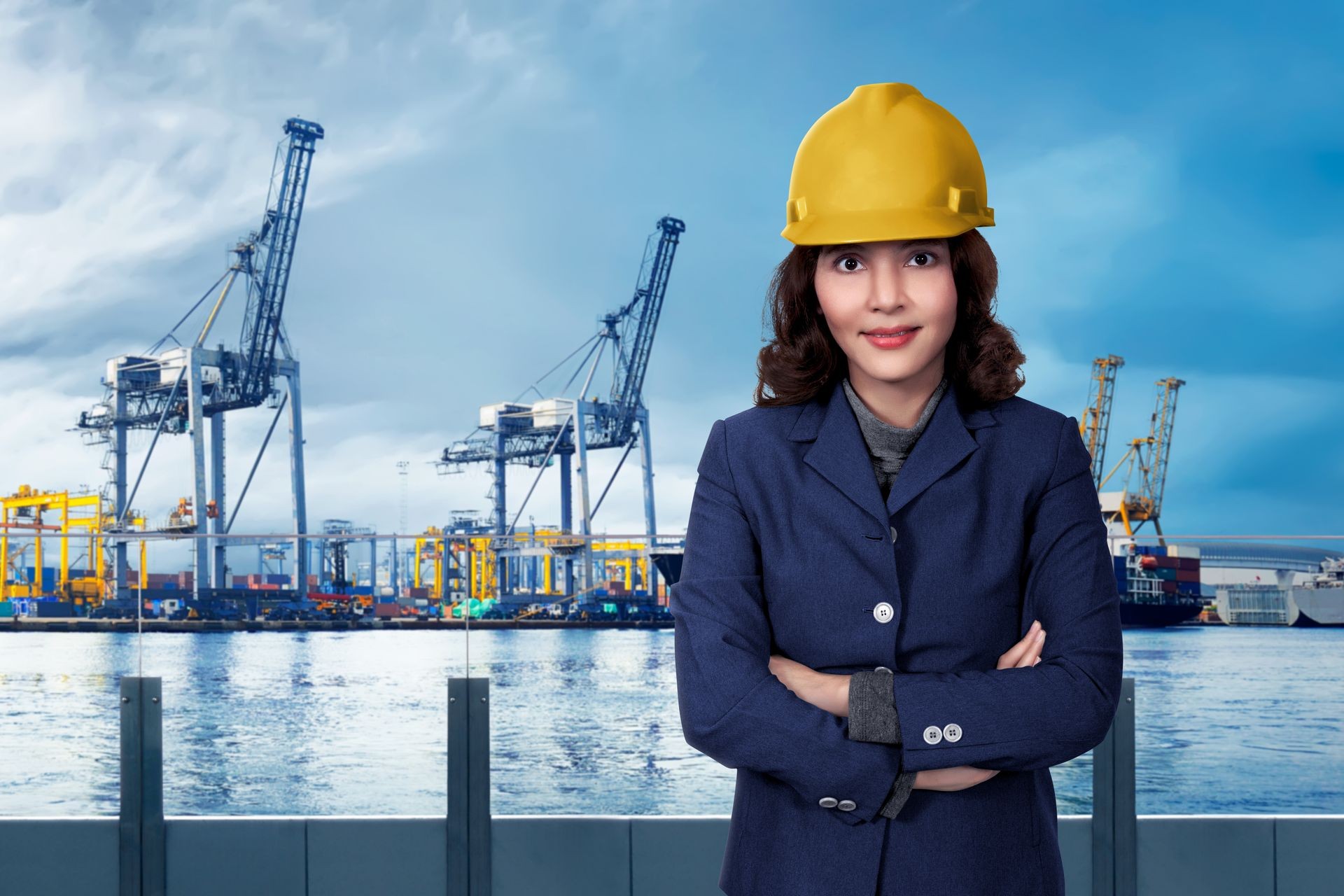 Portrait of a businesswoman happy in the harbor with a suit and a yellow helmet