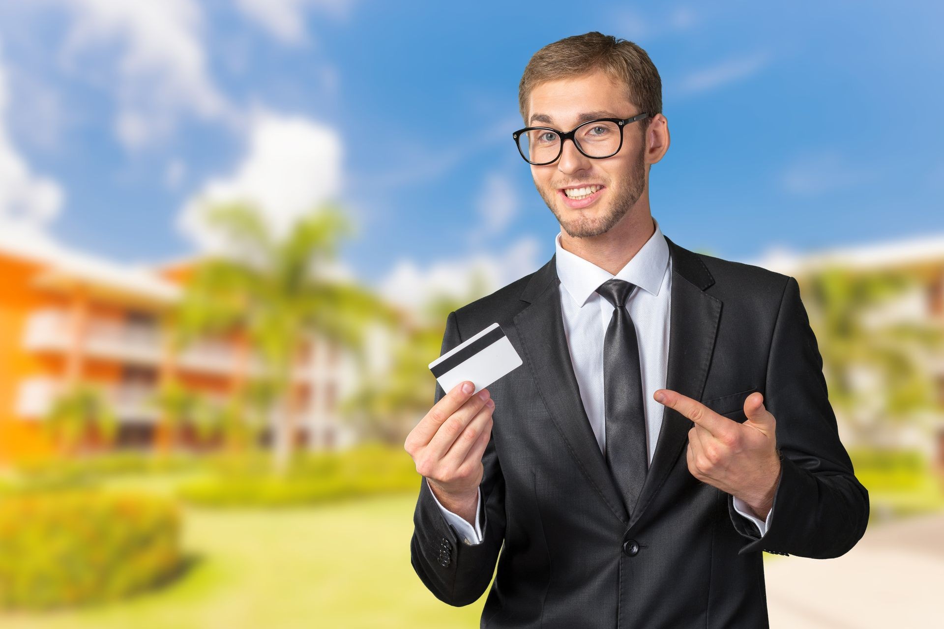 Young happy  man holding credit card